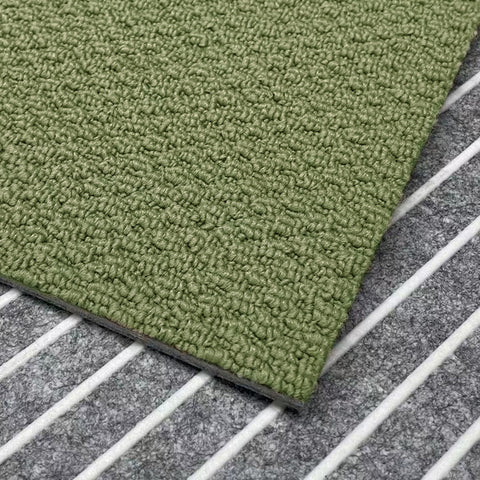 A close-up view of the olive Matace carpet sqares.