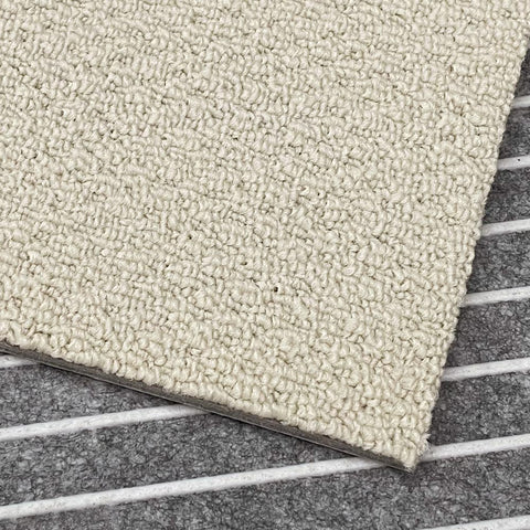 A close-up view of the cream Matace carpet sqares.