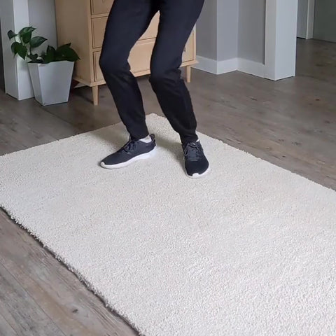 a women jump on the removable carpet tiles