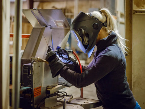 A women is welding at workshop