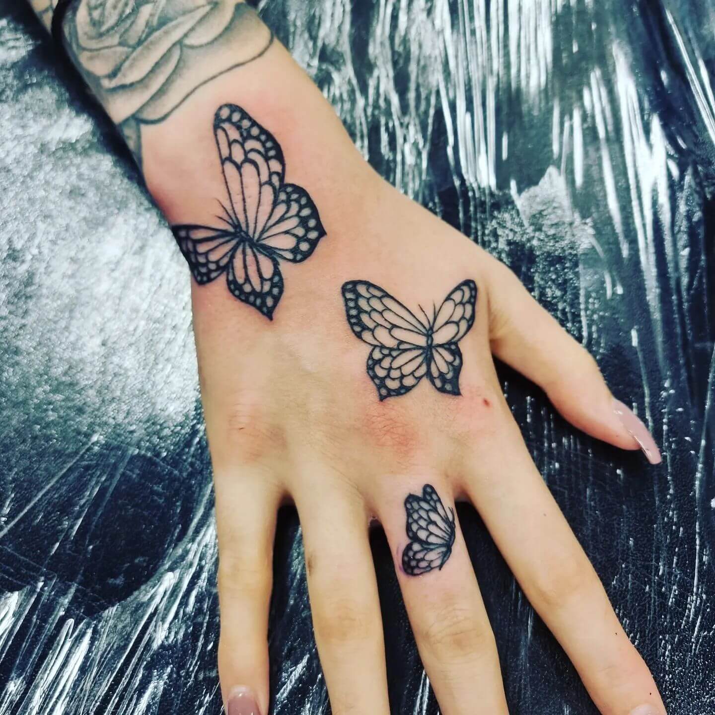 Black Butterfly Hand Tattoo