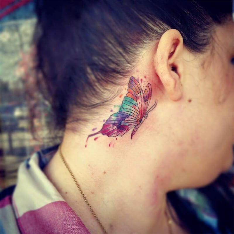 Colorful behind the ear butterfly tattoo