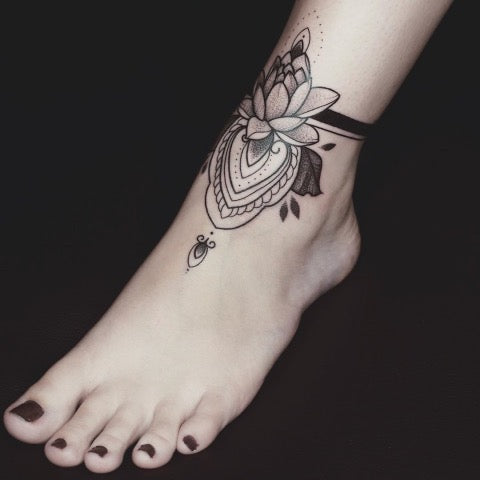 Cute small lotus flower tattoo done on the ankle.