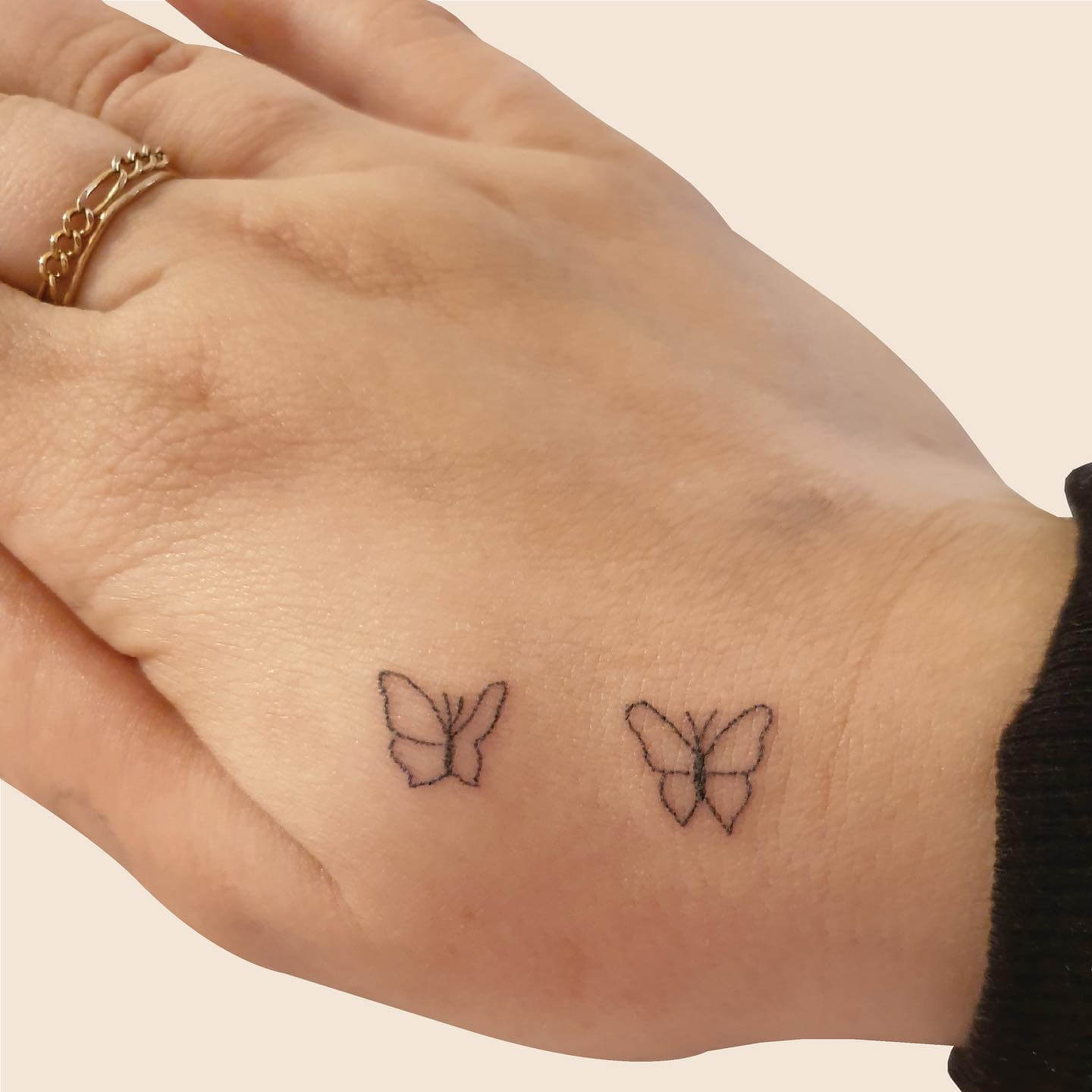 Simple Butterfly Hand Tattoo