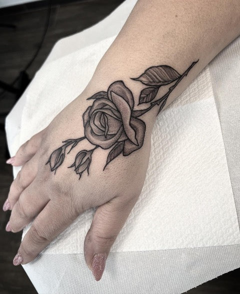 Small Rose Hand Tattoo