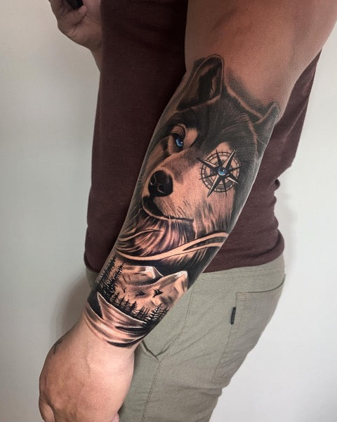 Wolf tattoo on the inner forearm