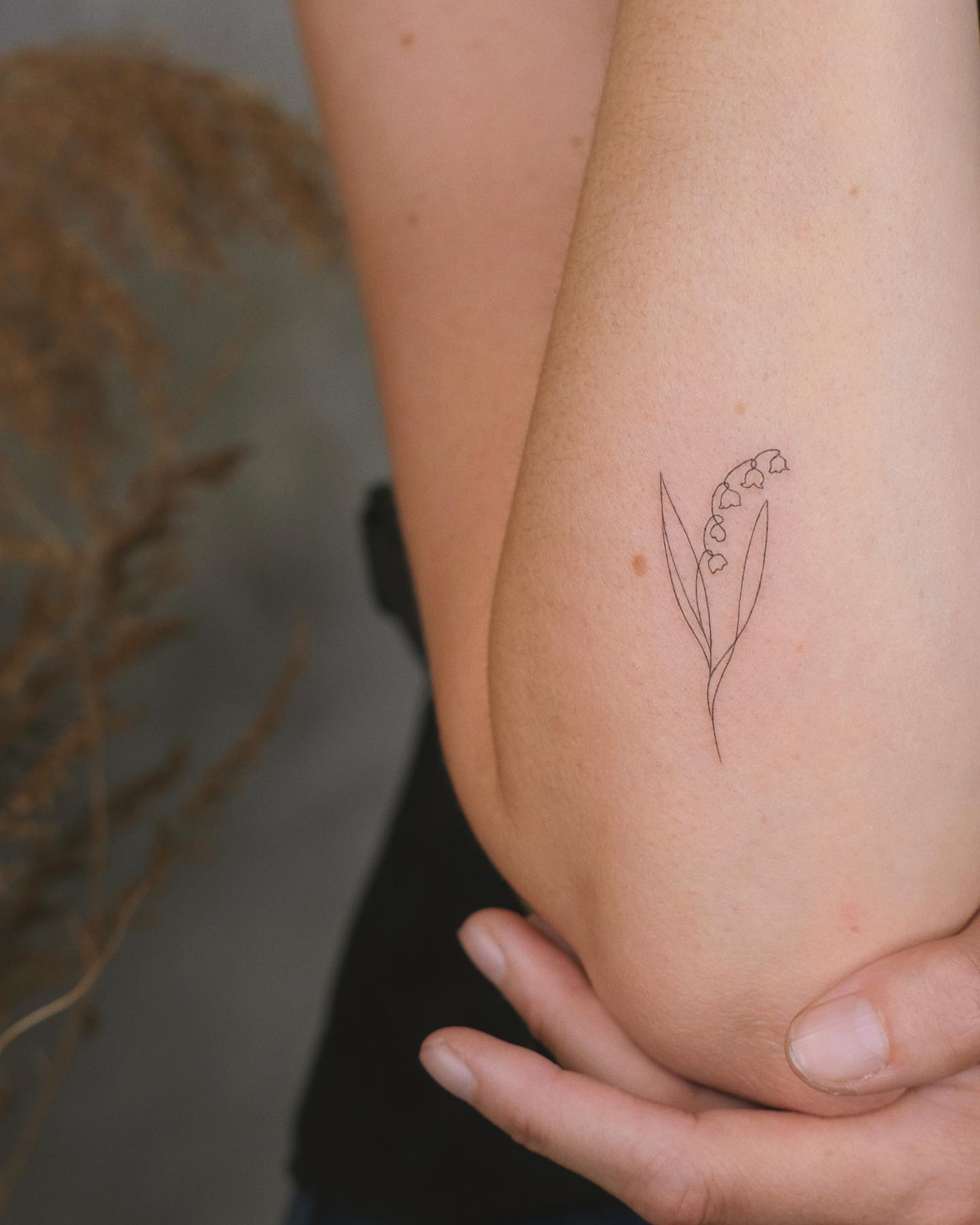 minimalist lily of the valley tattoo