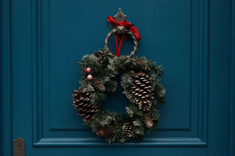 “A pine cone wreath on the door”