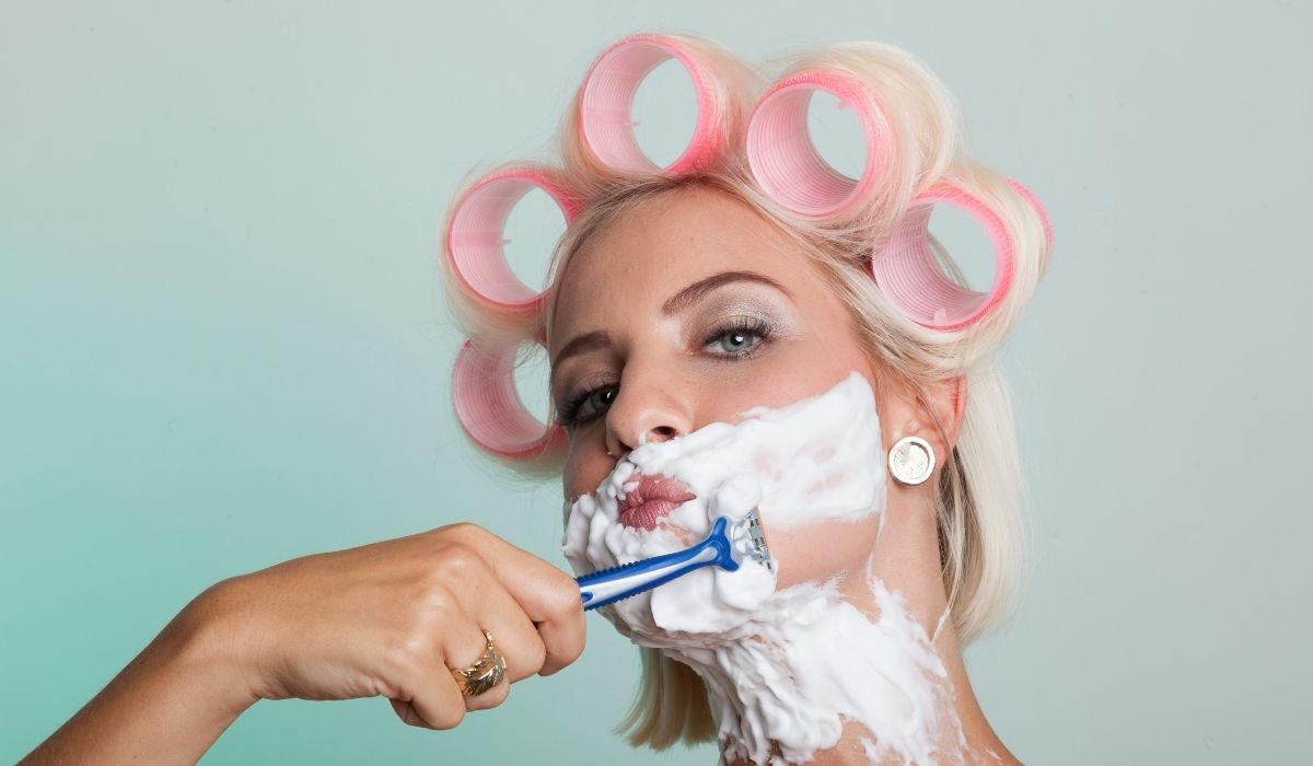 Woman shaving her face
