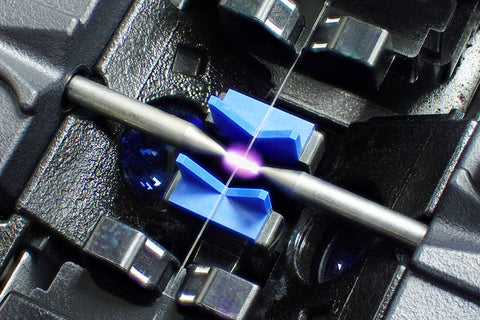 What does a fiber splicing machine do