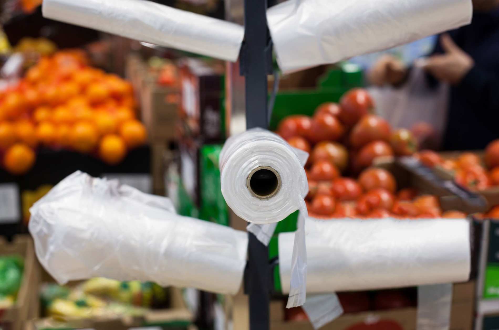 Perforated produce bags on rolls in a supermarket produce section