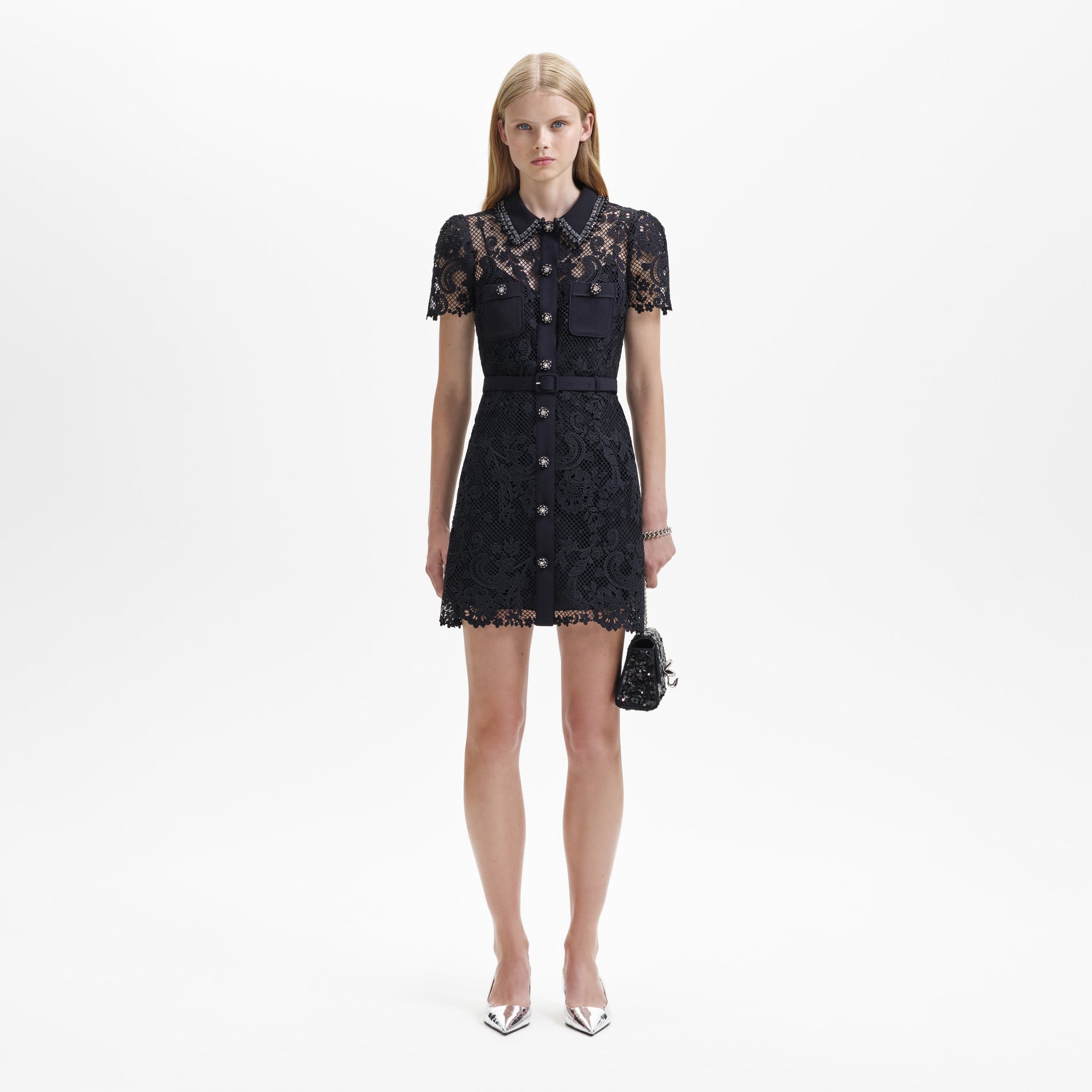 A woman wearing the Black Lace Button Front Mini Dress