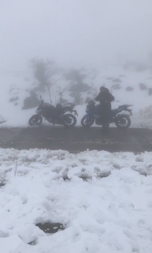 Climbing snowy mountains by motorcycle