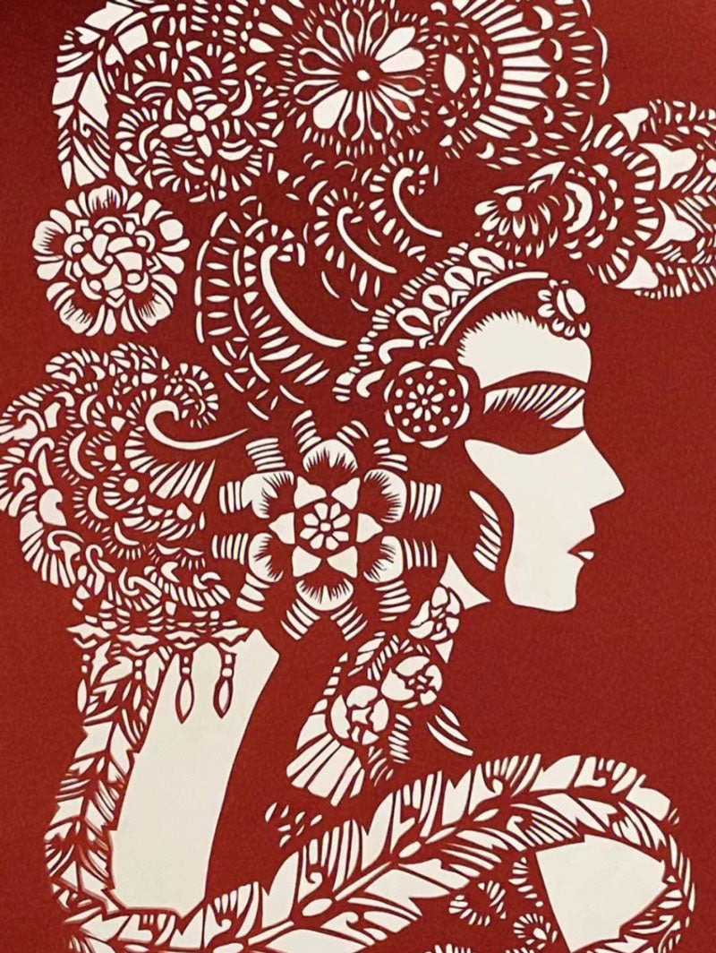 The paper-cut artwork titled "少女" by a folk artist