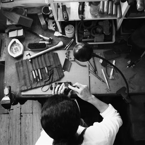 A craftsman working on wooden hair sticks