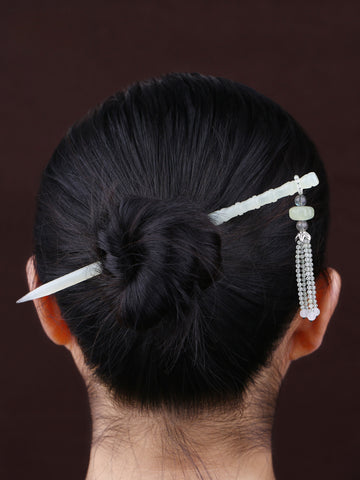 A woman wearing a jade hair stick