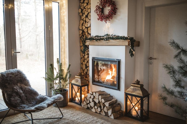 The soft grey faux fur blanket is on the chair beside the fireplace. Perfect Christmas gift in winter. Warm and easy to wash.