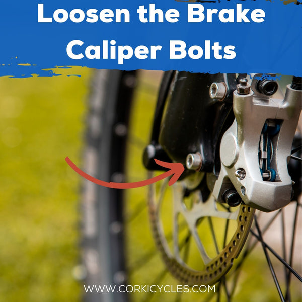 Loosen the brake caliper bolts-Corki Cycles