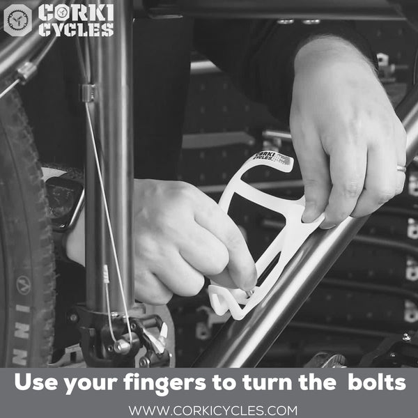 Use fingers to turn the bolts to install the bottle cage - Corki Cycles