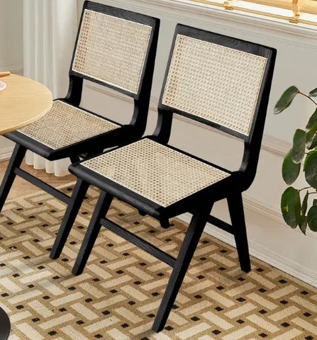 2 black wood cane chairs