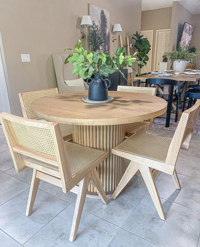 2 Modern Wood Cane Chairs beside solid wooden end table