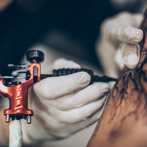 tattoo artist working with