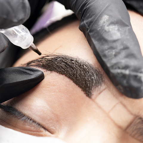 Tattoo artist making Eyebrow Tattoo