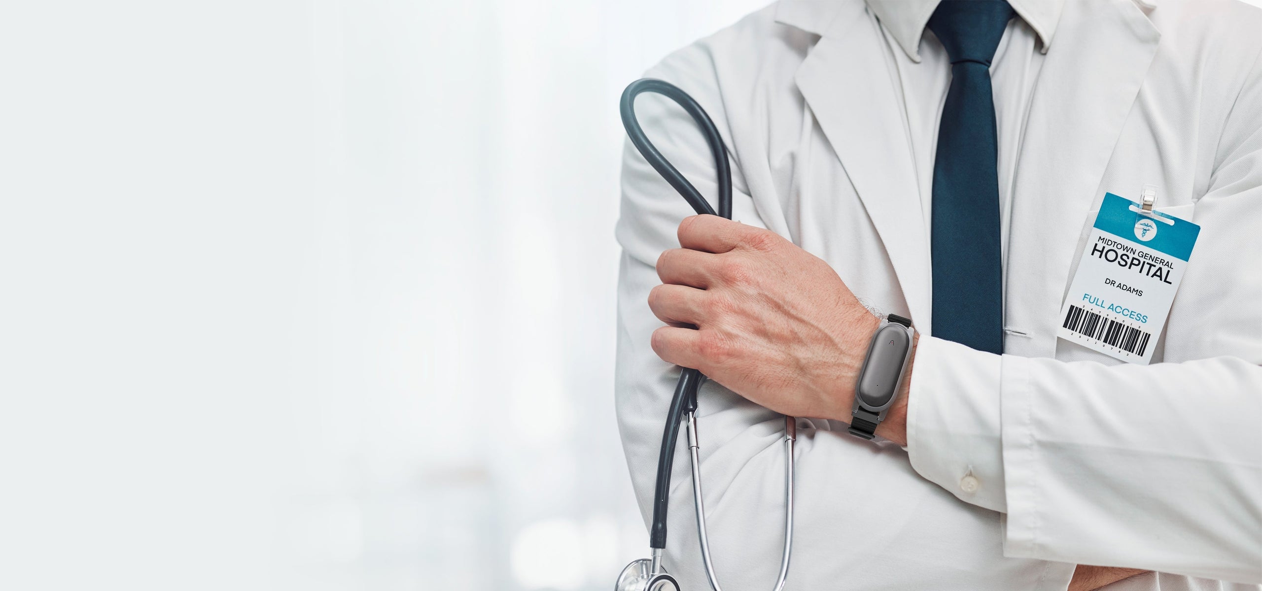 Medical professional wearing a Cosmic Gray Plaud NotePin on a wristband, holding a stethoscope.