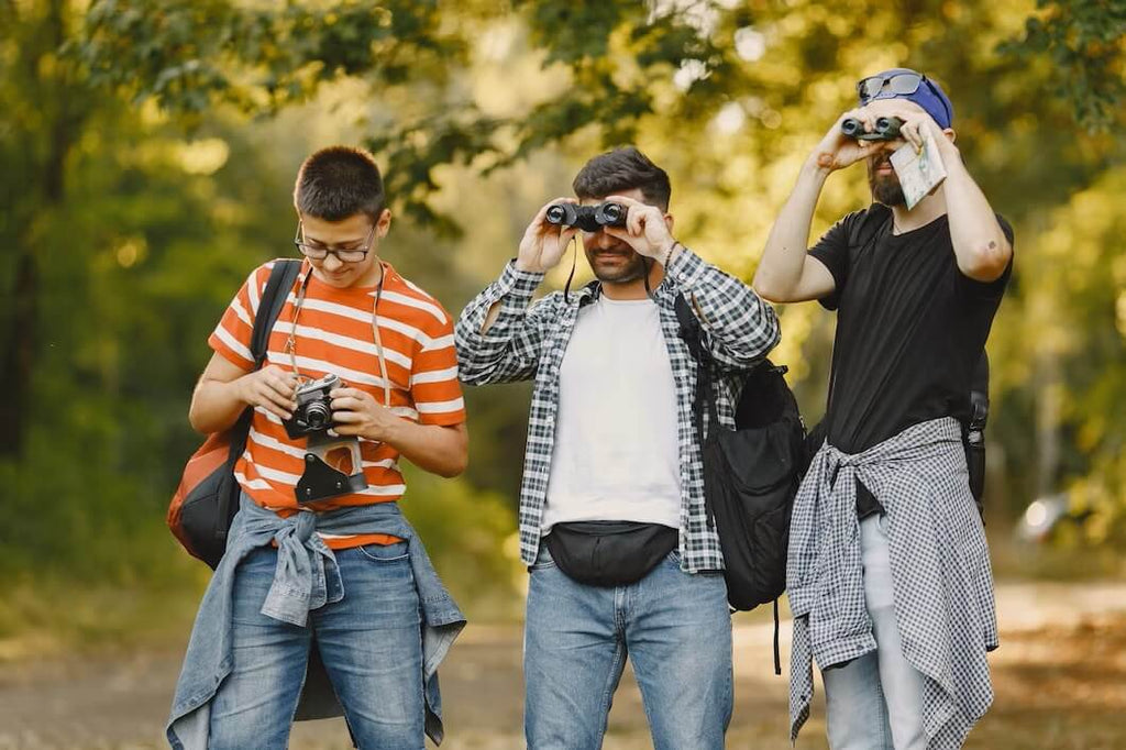 adventure-hike-people-concept-group-smiling-friends-forest-man-with-binocular