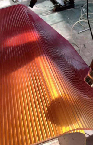 A close up of a cracked acrylic sheet with a jagged split down the middle, an example of an unsuccessful bend.