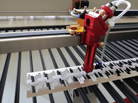 Beeplastic's industrial laser cutter head precisely machining a complex plastic part.