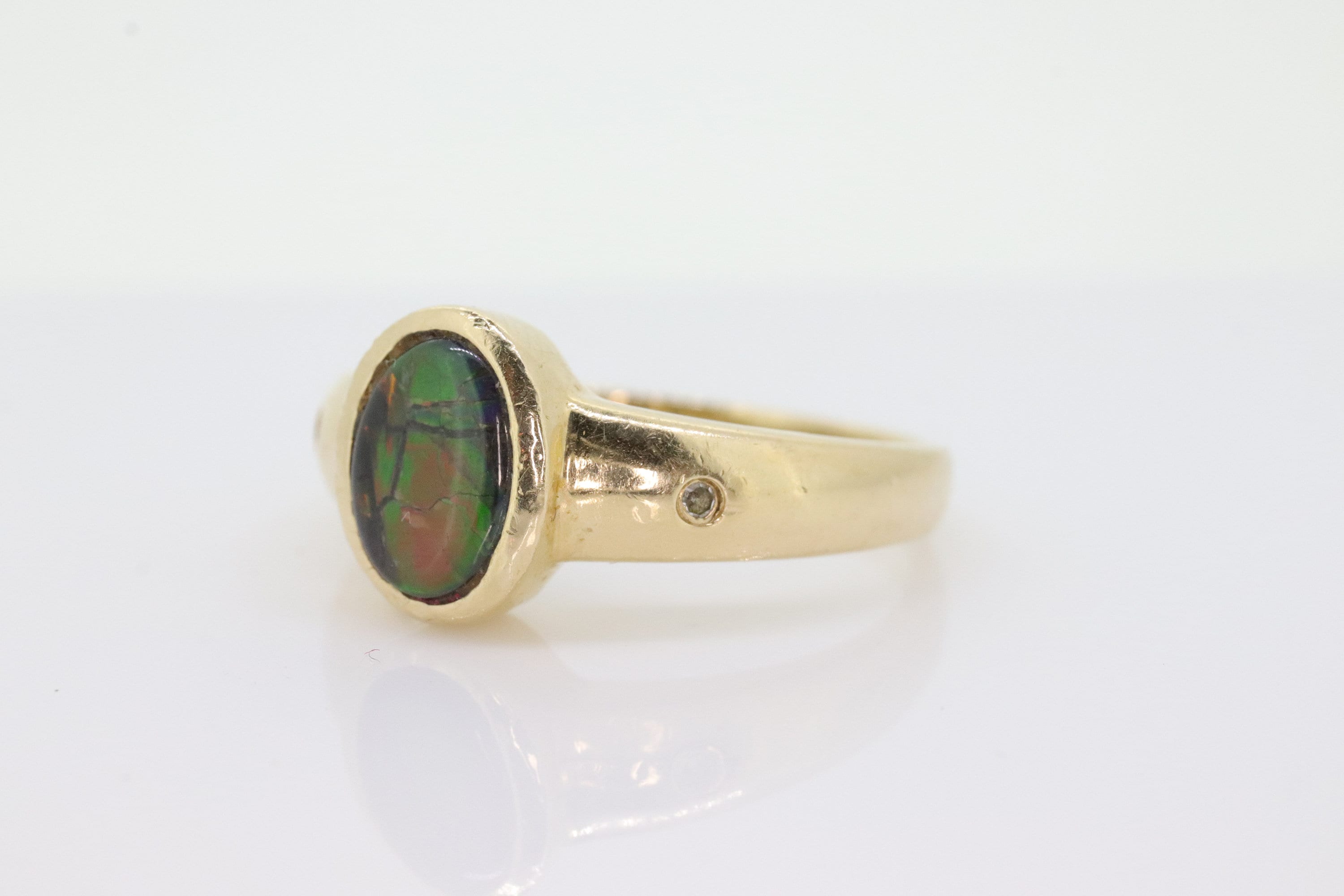 14k Oval Bezel Set Ammolite Ring. Ammolite Fossil and diamond ring. Ammolite Bezel set. st70