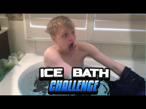 A young boy reacts to the cold water in an ice bath, participating in an ice bath challenge.