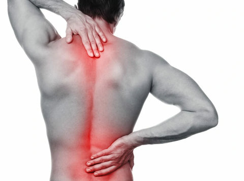A person with hands on their back shows signs of discomfort, potentially benefiting from cold baths for pain relief.