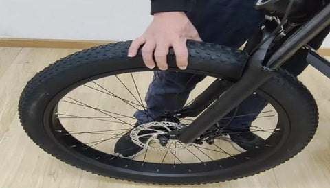 Step 4 : Align the fork dropouts with the axle of the wheel hub, making sure the dropouts are securely positioned on the axle. Also ensure the brake rotor is properly inserted into the caliper.