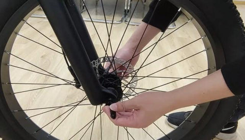 Step 4 : Align the fork dropouts with the axle of the wheel hub, making sure the dropouts are securely positioned on the axle. Also ensure the brake rotor is properly inserted into the caliper.