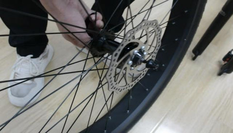 Step 2: Install the quick-release skewer starting from the brake rotor side of the wheel, inserting the quick-release skewer through the hub and then replacing the second cone spring on the other side.Ensure both springs are pointed narrow-side-in towards the wheel hub.