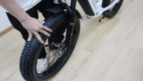 Step 4 : Align the fork dropouts with the axle of the wheel hub, making sure the dropouts are securely positioned on the axle. Also ensure the brake rotor is properly inserted into the caliper.