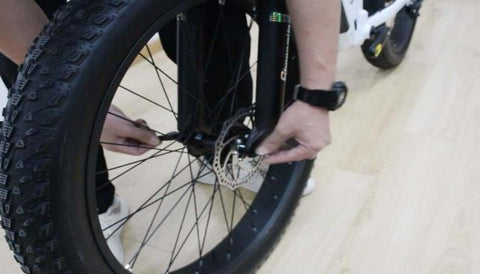 Step 4 : Align the fork dropouts with the axle of the wheel hub, making sure the dropouts are securely positioned on the axle. Also ensure the brake rotor is properly inserted into the caliper.