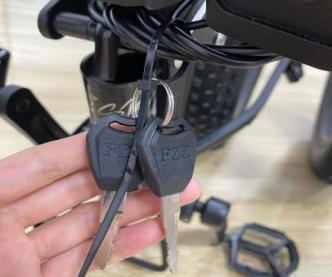 Step 1: Find the keys located on the handlebar and remove them. If you cut them from the handlebars, be careful not to damage any of the wires. NOTICE: Please keep your key and its spare in a safe place. Once lost, they are difficult to copy.