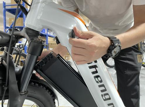 Step 2: Use the key to unlock the battery. While holding the battery with one hand, detach the battery by turning the release switch located on the underside of the frame.