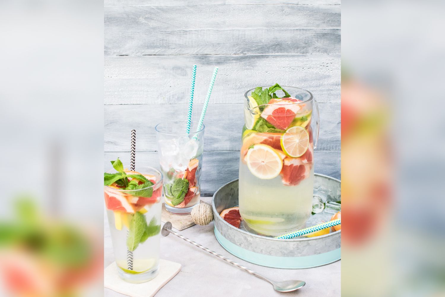 photo of bottles of fruit(lemon and grapefruit) drinks in front ofTiled wallpapers