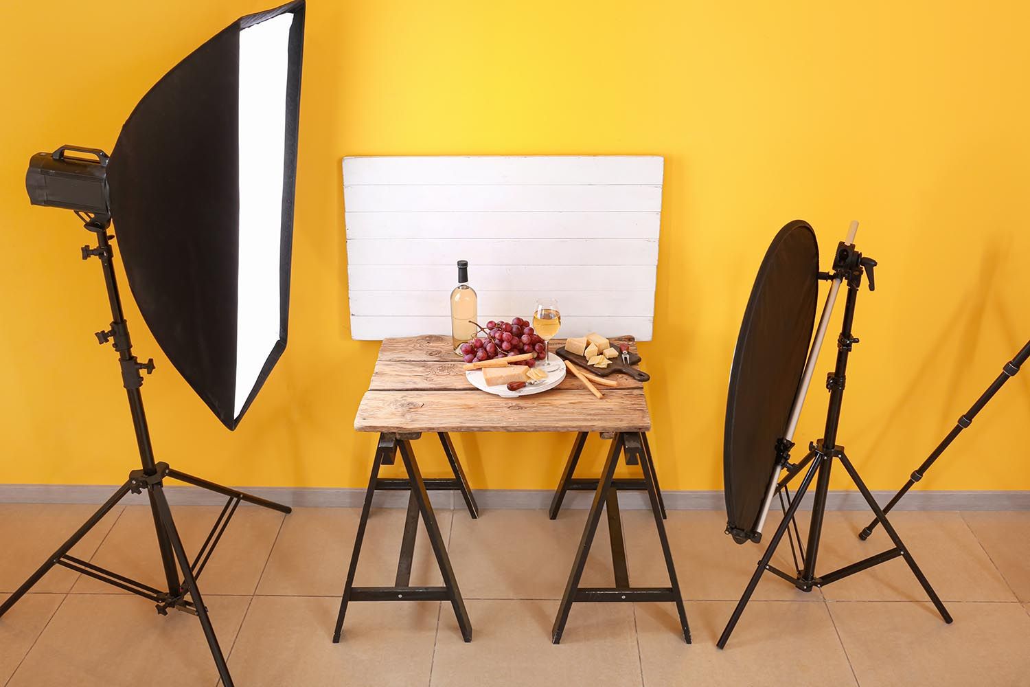 photography setup of grapes and sliced butter in front ot White Flat Stone