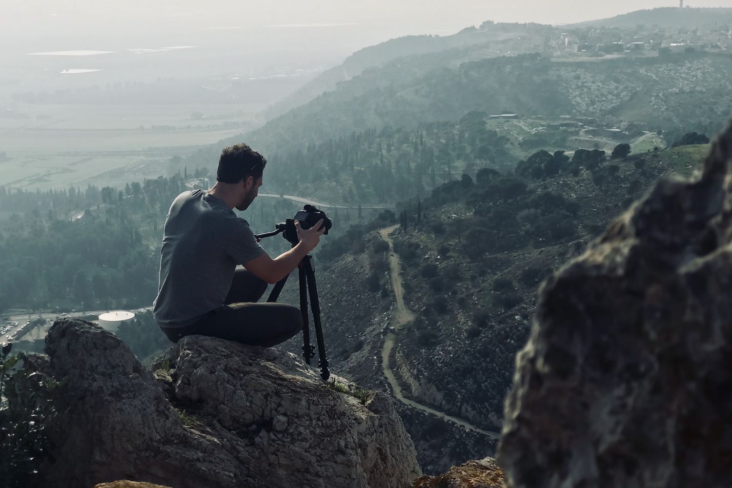 man taking photo on hills