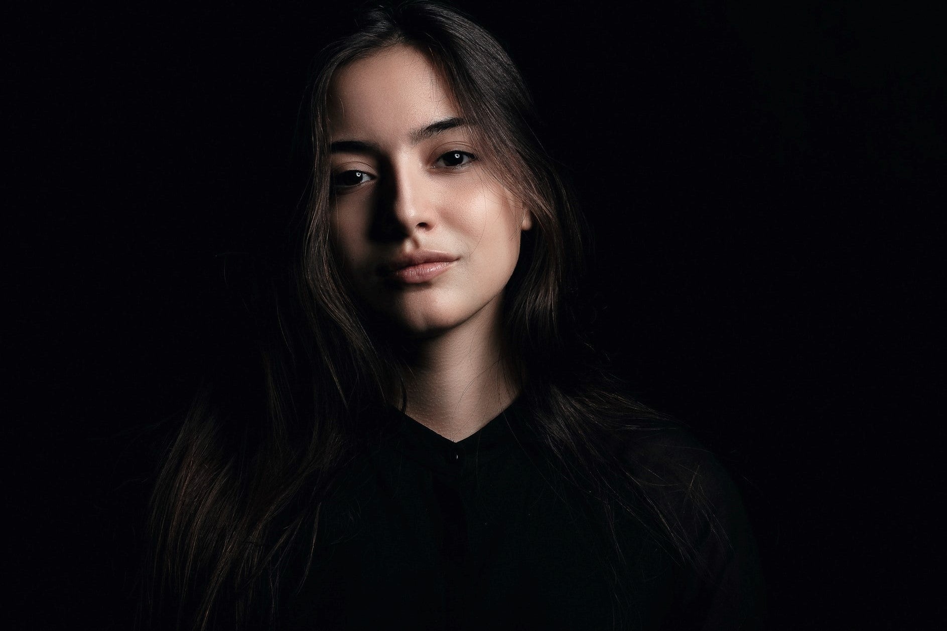 headshot of a girl in black background