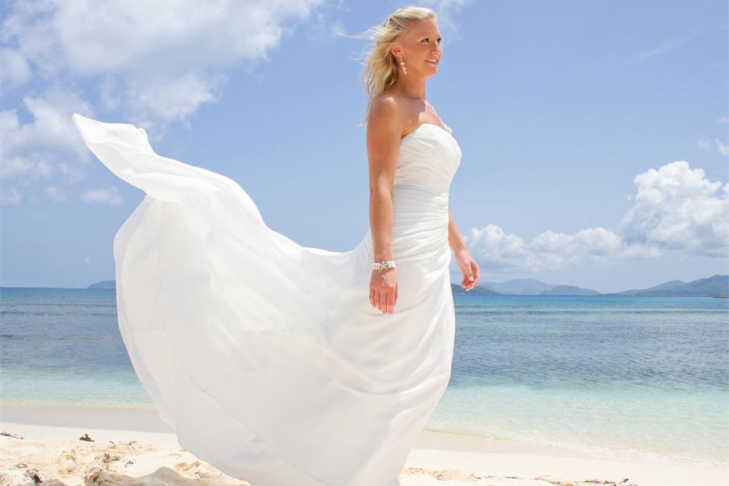 bride wearing fabric wedding dress on beach