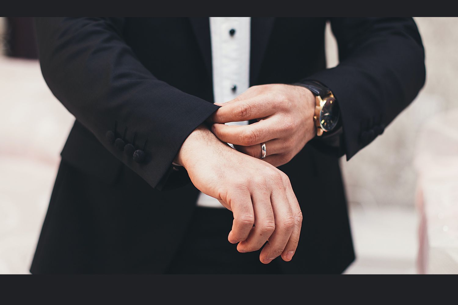 man with a watch is organizing the cuffs