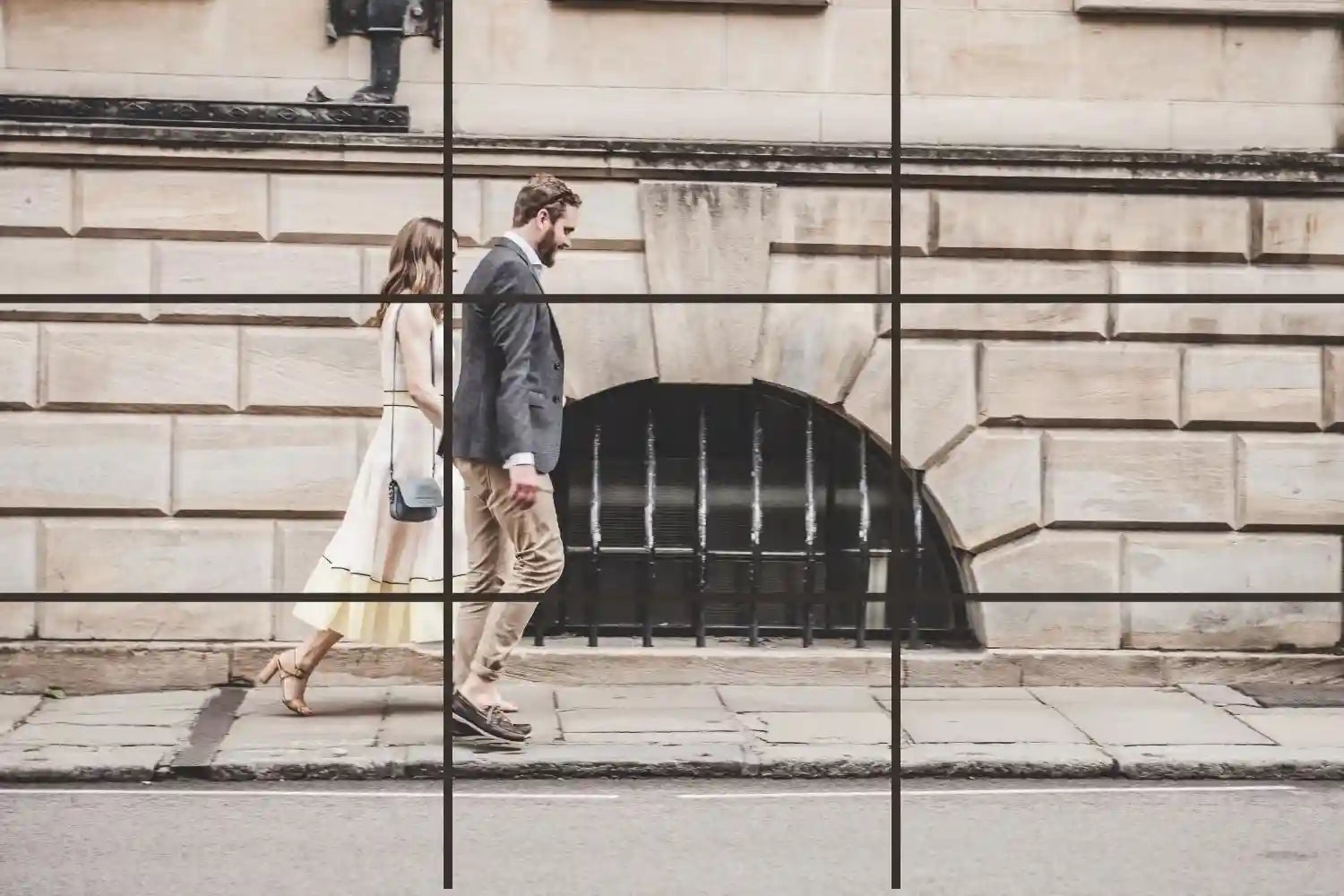 A man and a woman walking hand in hand on the street