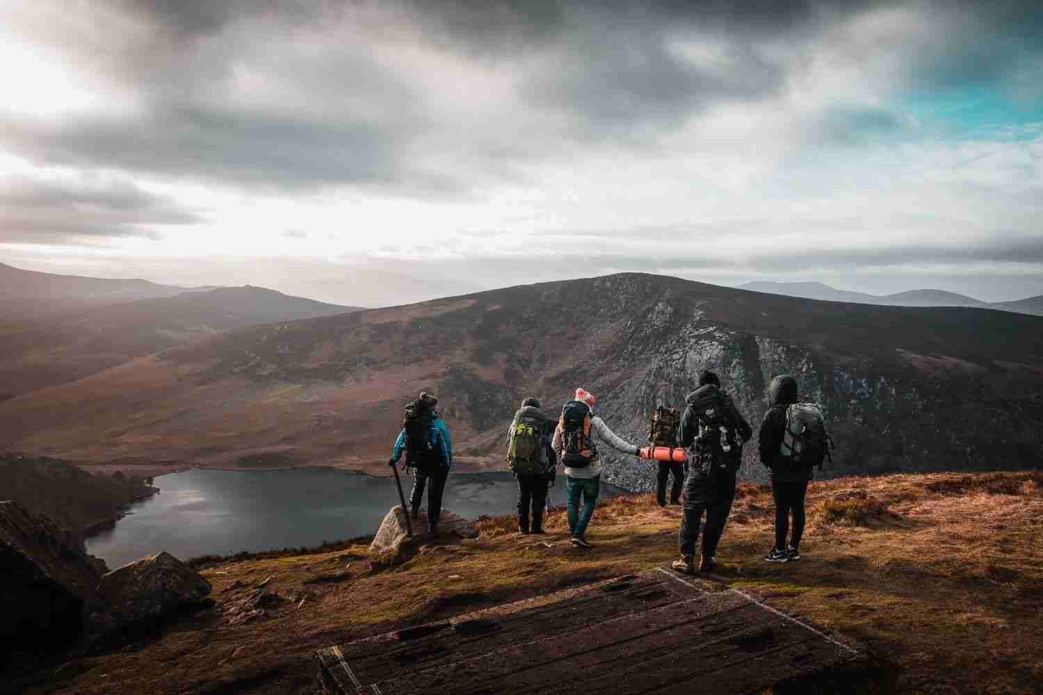 some mountaineers carrying bags are standing on the mountain