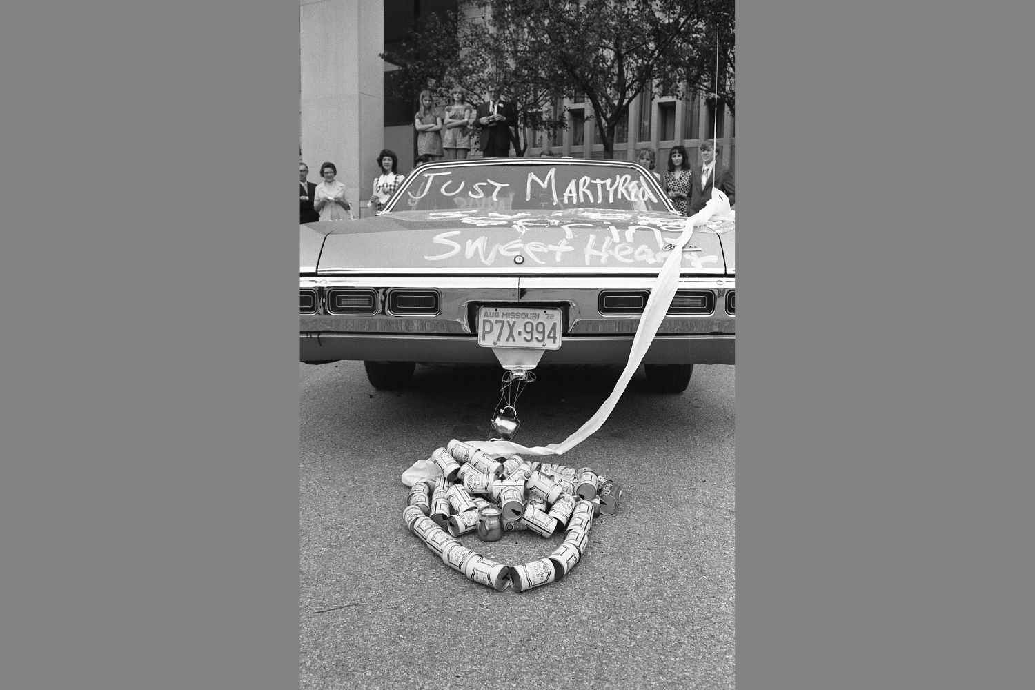 The Just Married sign is hung from the back of the car